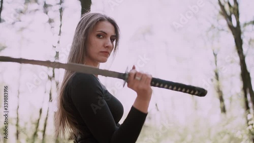 Portrait of a pretty girl with a samurai sword .Girl with a samurai sword fought at sunset.martial arts