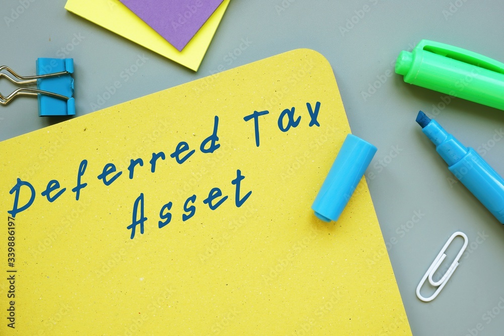 The photo shows Deferred Tax Asset. Notepad, heap, marker. The photo shows Deferred Tax Asset. Notepad, heap, marker.