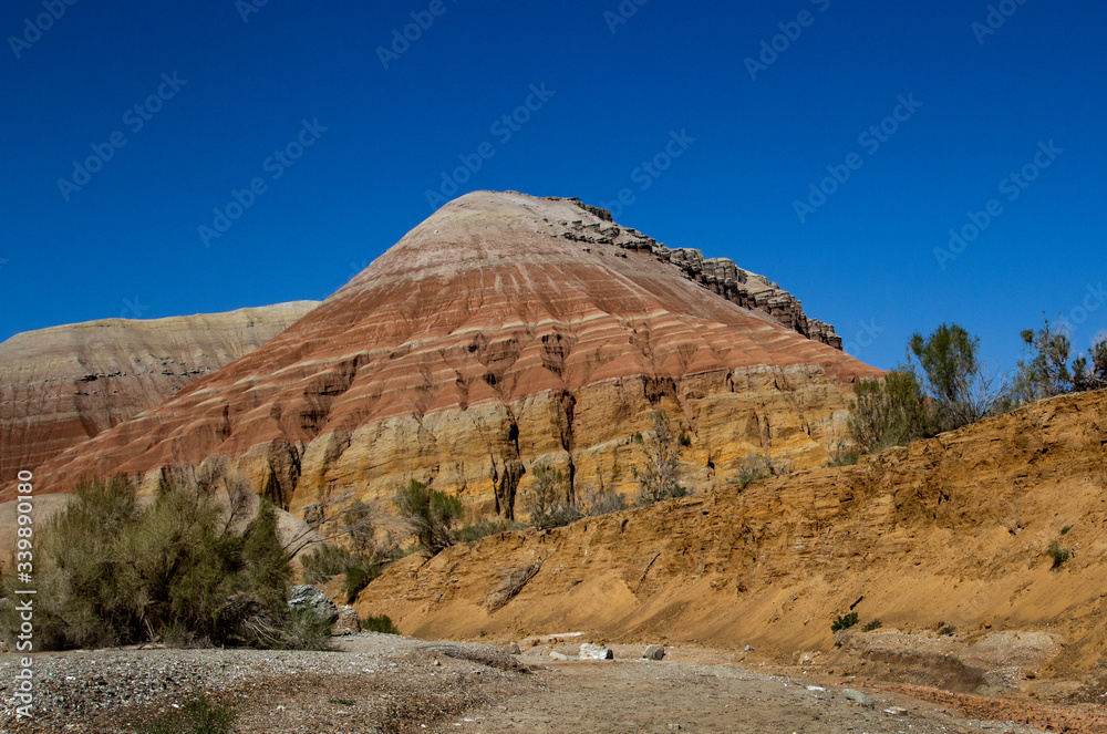 Colored, layered Aktau mountains in Kazakhstan among saxaul bushes. Colored, layered Aktau mountains in Kazakhstan among saxaul bushes.