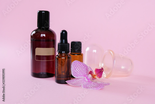 Essential oils , various bottles aromatherapy on a pink background. Aromatherapy and perfumes concept