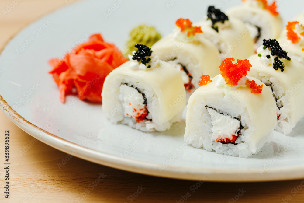 Sushi set roll three cheeses. Rice, nori, toast cheese, cream cheese, feta cheese. Online delivery on quarantine. Concept of healthy organic food. Sushi set roll three cheeses. Rice, nori, toast cheese, cream cheese, feta cheese. Online delivery on quarantine. Concept of healthy organic food.