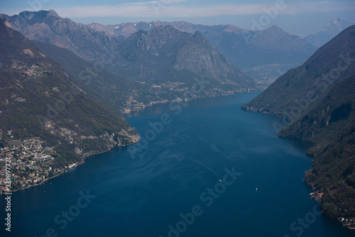 The river flows between the mountains, blue water in the lake, a beautiful landscape from above on a lake in Switzerland