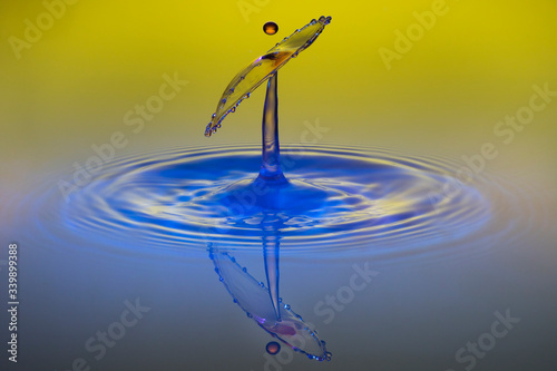 water drop collision on yellow background