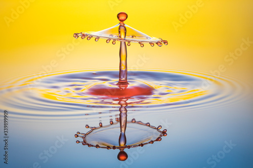 water drop collision on yellow background