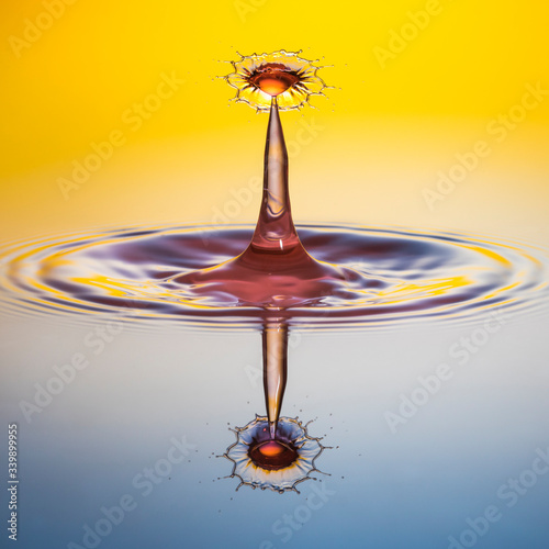 water drop collision on yellow background