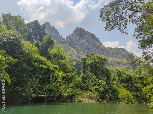 Green jungles in mountains. Green forest and water reflection.