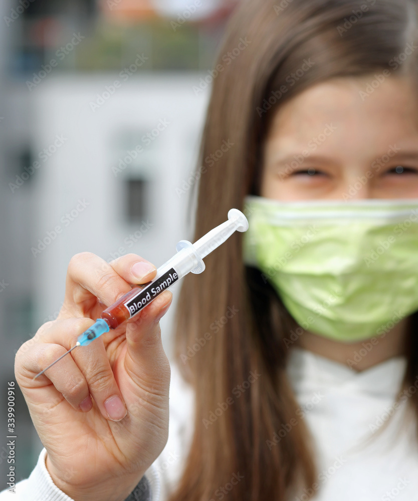 hand of young nurse wears surgical mask with syringe containing hand of young nurse wears surgical mask with syringe containing