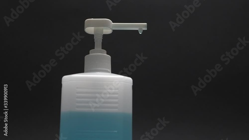 Hand disinfection with antibacterial on a black background. Protection against bacteria and viruses.