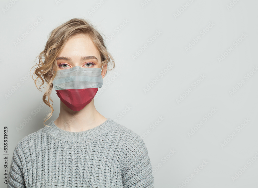 Young woman wearing a face mask with flag. Flu epidemic and virus protection concept Young woman wearing a face mask with flag. Flu epidemic and virus protection concept