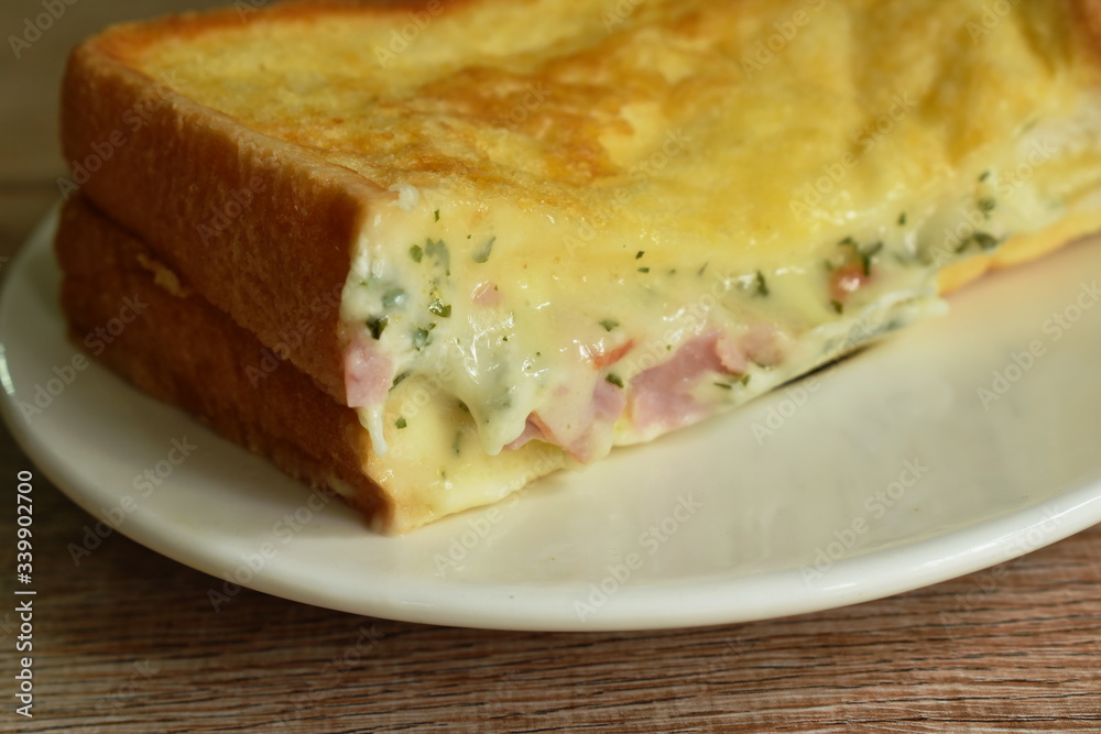 French toast sandwich stuffed bacon and cheese on plate French toast sandwich stuffed bacon and cheese on plate