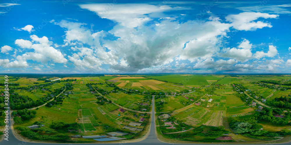 360-degree pano of Aerial view of a beautiful landscape with white clouds in the colorful sky. Aerial view of the countryside with village and fields of crops in summer.