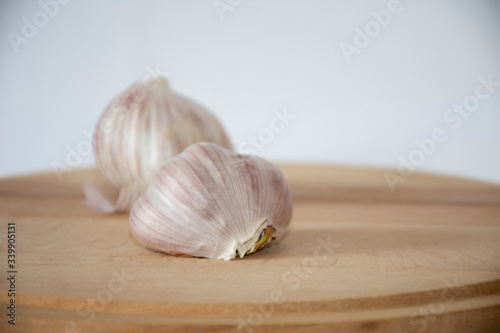 Garlic on a wooden board with a white background