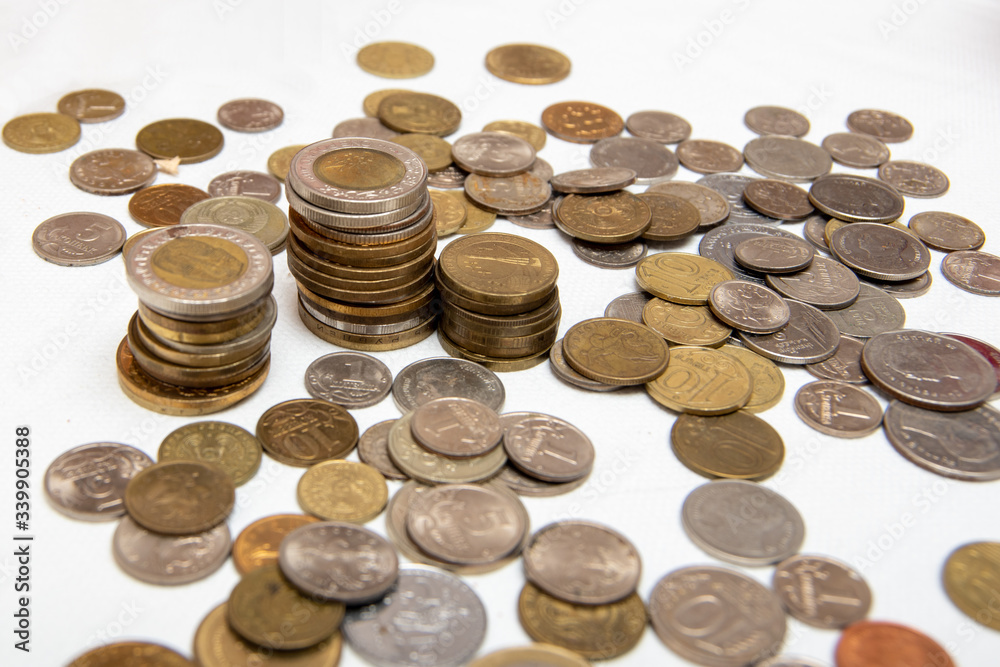 Several coins of different countries, on a white background, close-up Several coins of different countries, on a white background, close-up