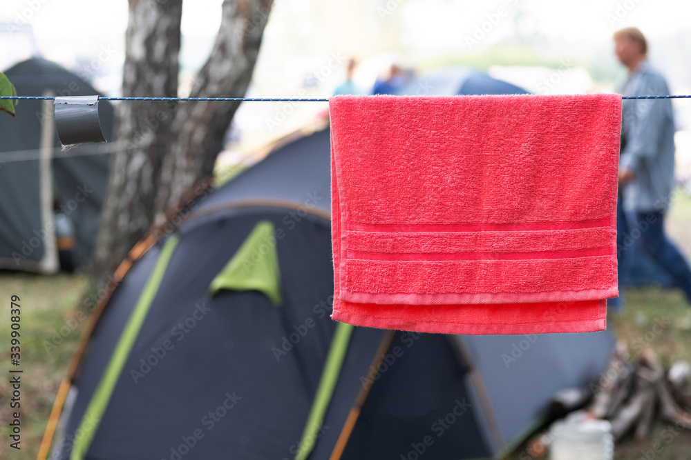 red towel on a rope near the tents