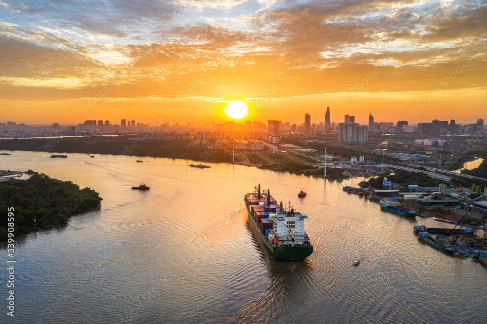 Fototapeta premium Aerial view of center Ho Chi Minh City, Vietnam with development buildings, transportation, energy power infrastructure. View from the Saigon river with ships on the river.