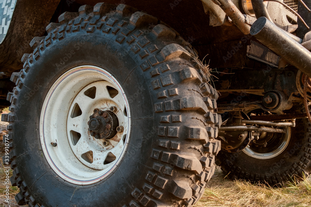 big wheel with high tread on wet grass