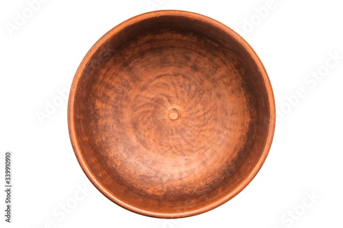 Clay bowl isolated on white. Closeup of a clay bowl, top view.