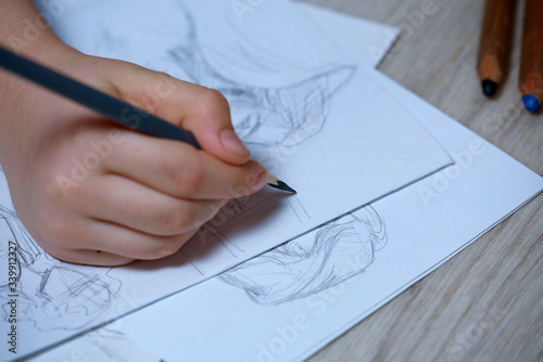 Sketches, sketching on white paper with a simple pencil. Colour pencils