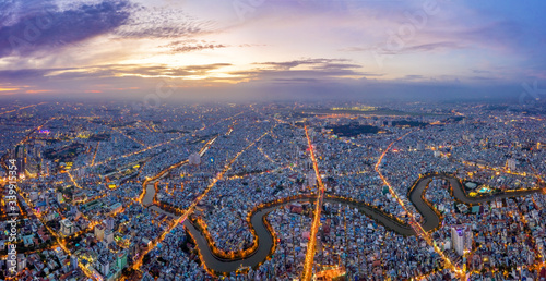 Top view aerial of Ho Chi Minh City, Vietnam with Nhieu Loc - Thi Nghe canal and Tan Son Nhat airport, with development buildings, transportation, energy power infrastructure. View from District 3 photo