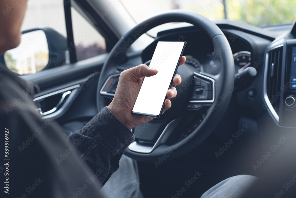 Man using smartphone inside car