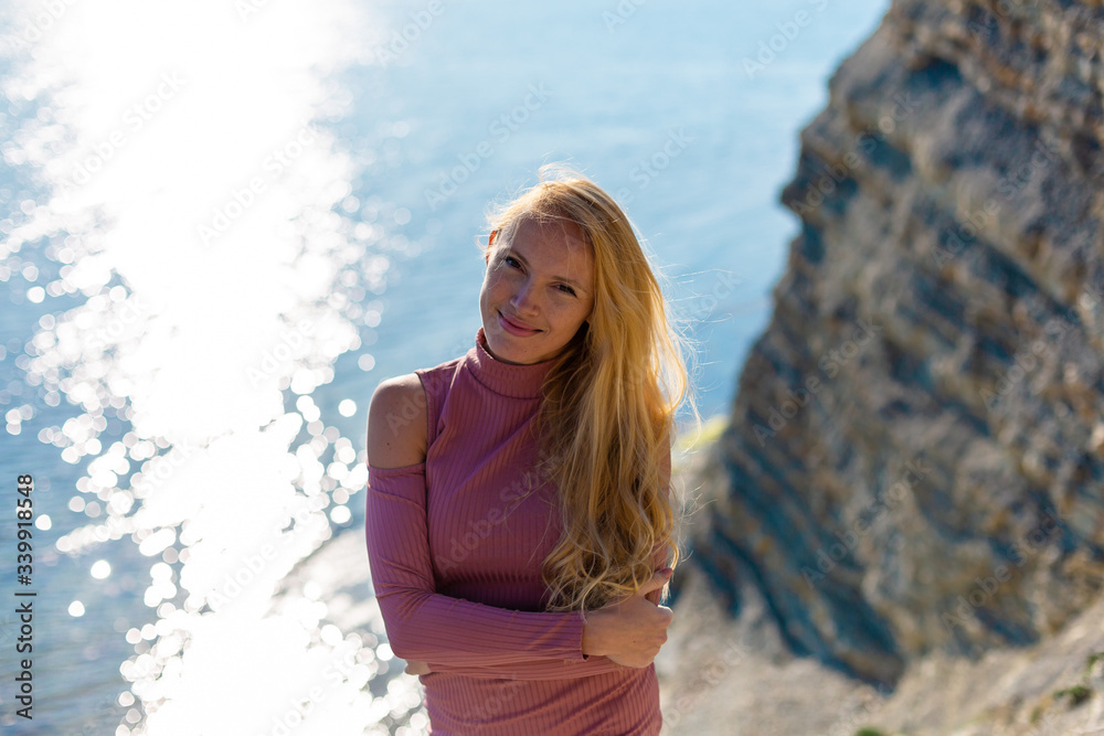 blonde model on the beach at the summer