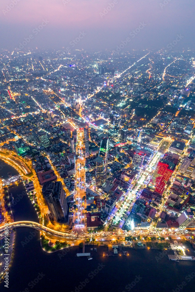 Obraz premium Top view aerial photo from flying drone of a Ho Chi Minh City with development buildings, transportation, energy power infrastructure. Financial and business centers in developed Vietnam.