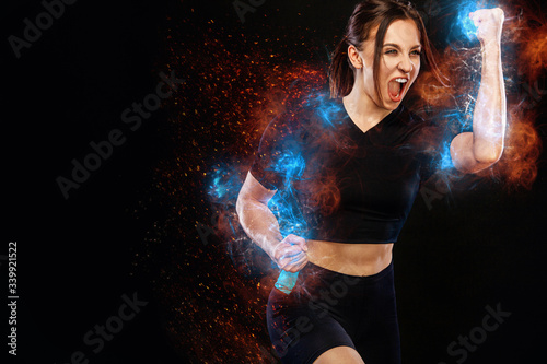 Sprinter and runner girl. Running concept. Fitness and sport motivation. Strong and fit athletic, woman sprinter or runner, running on black background in the fire wearing sportswear.