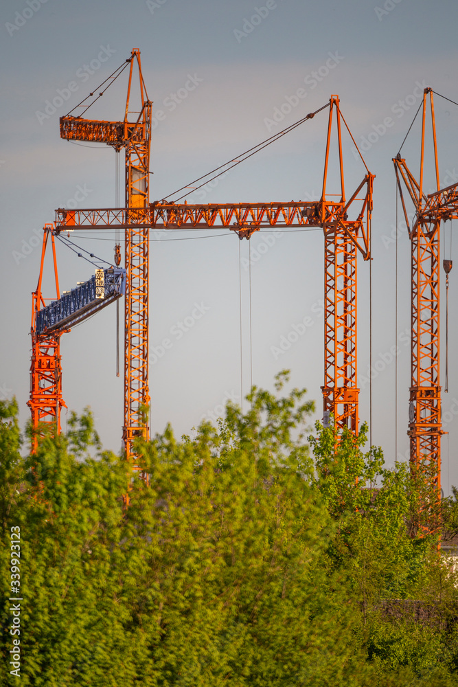 Construction cranes at a building site in a new development area in Germany Construction cranes at a building site in a new development area in Germany