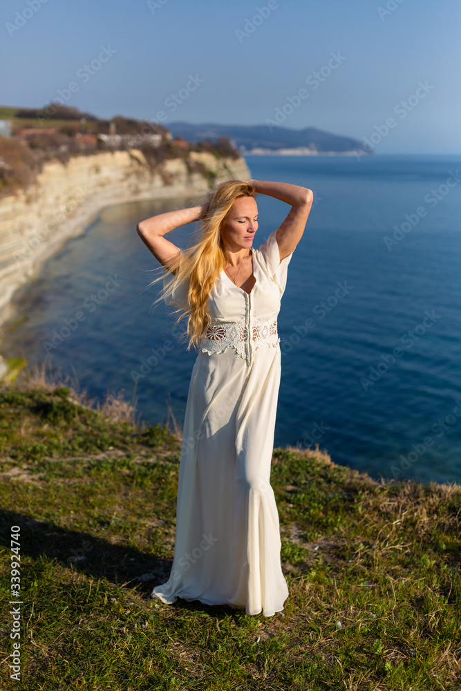 Blonde model at the sea at summer