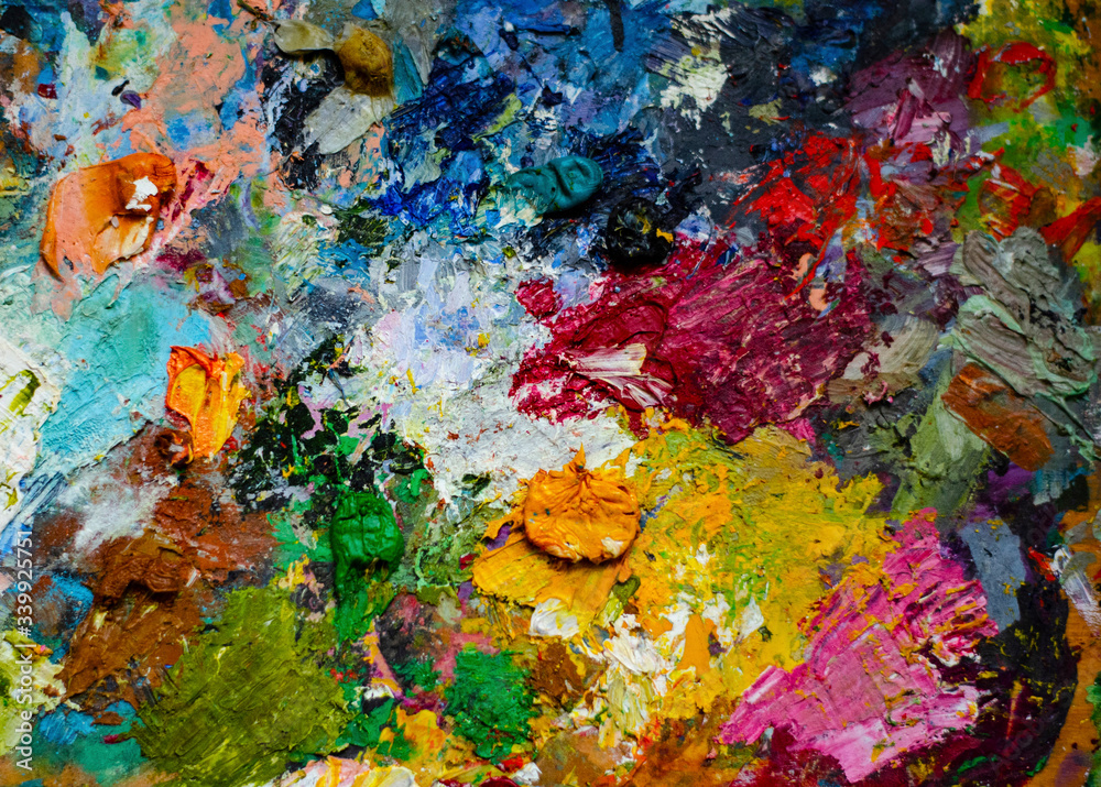 Artist's palette with oil paints. Multicolor abstract background. Oil paints on the palette Artist's palette with oil paints. Multicolor abstract background. Oil paints on the palette