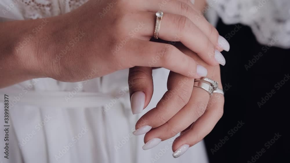 girl in a white coat strokes hands girl in a white coat strokes hands