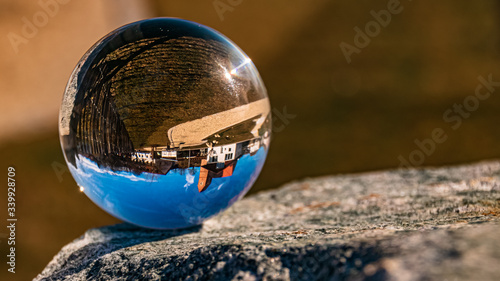 Crystal ball landscape shot on a rock with a beautiful church at Oberuttlau, Bavaria, Germany