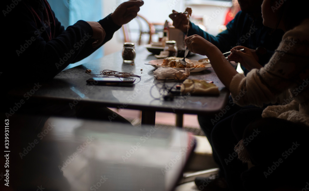 Silhouette of a group of young friends having lunch in a restaurant in a festive day. Indian lifestyle. Silhouette of a group of young friends having lunch in a restaurant in a festive day. Indian lifestyle.