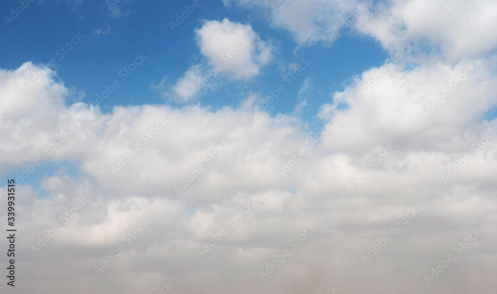 Fototapeta premium clouds swiftly swim through the blue sky of the day