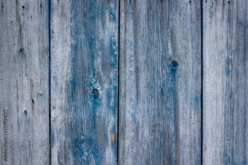 old wooden painted wall with cracked and sometimes peeling paint