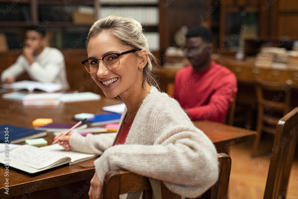 Fototapeta premium Happy female student in library