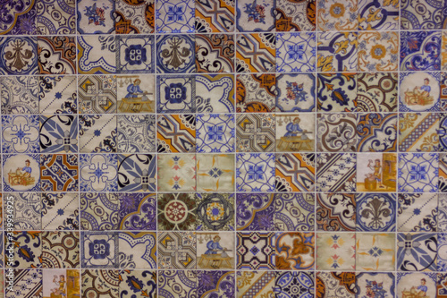 wall of multicolored tiles with ethnic patterns pottery retro © Irina