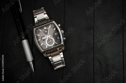 Luxury watches with a metal strap on the leather surface with handle