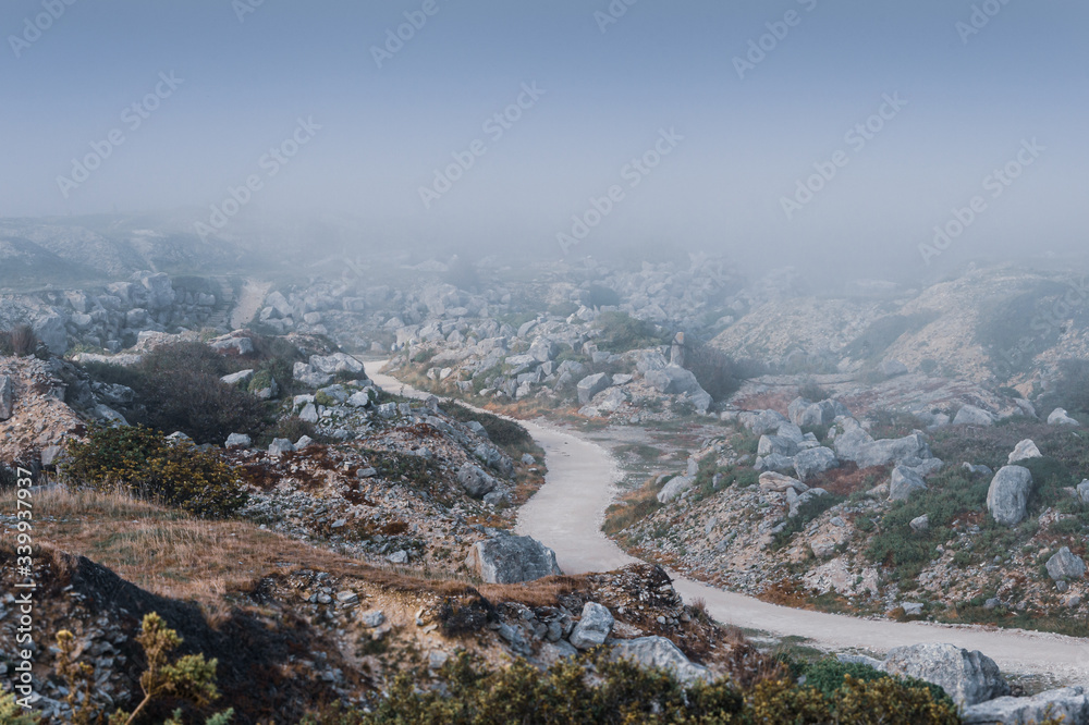 Atmospheric view overlooking a deserted Tout Quarry sculpture park and nature reserve on a foggy summer afternoon, Isle of Portland, Dorest, UK