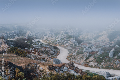 Atmospheric view overlooking a deserted Tout Quarry sculpture park and nature reserve on a foggy summer afternoon, Isle of Portland, Dorest, UK