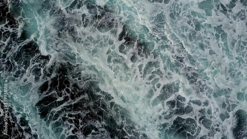 Aerial top view of giant ocean waves crashing and foaming. Slow motion, Indonesia, Bali
