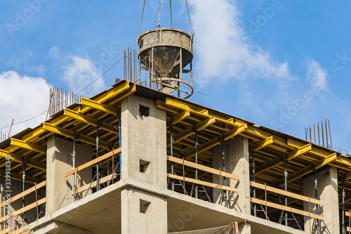 Facilities with concrete. Construction of a new residential complex for young families. Concept business, real estate, mortgage. Sunny clear day. Outdoors.