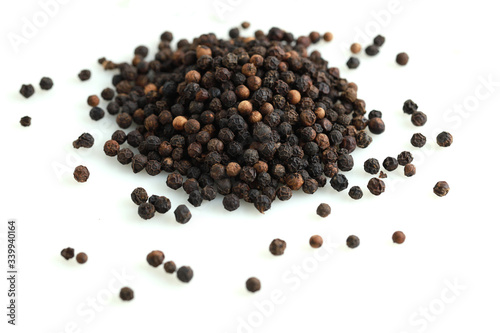 Pile of black peppercorns isolated on white