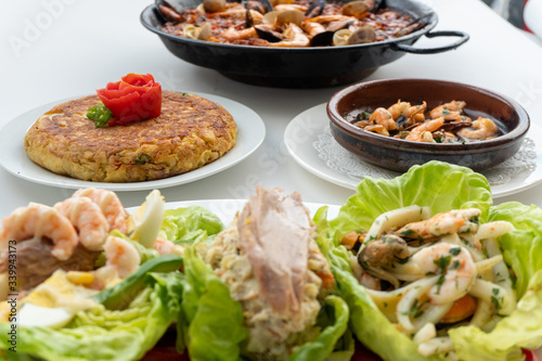 Fototapeta Naklejka Na Ścianę i Meble -  Spanish food together in one shot, paella, Tortilla espanola, Gambas Pil Pil, Ensalada de Pescado