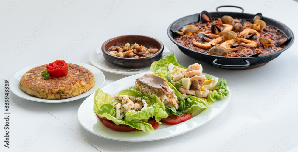 Spanish food together in one shot, paella, Tortilla espanola, Gambas Pil Pil, Ensalada de Pescado Spanish food together in one shot, paella, Tortilla espanola, Gambas Pil Pil, Ensalada de Pescado