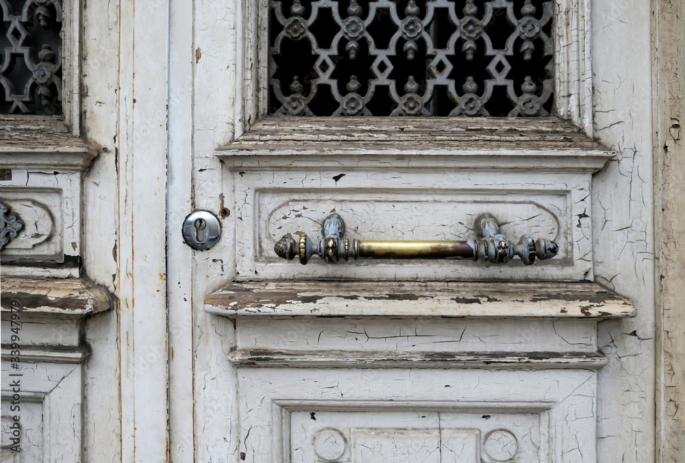 Old metal door handle lock on white wooden door. Door knob