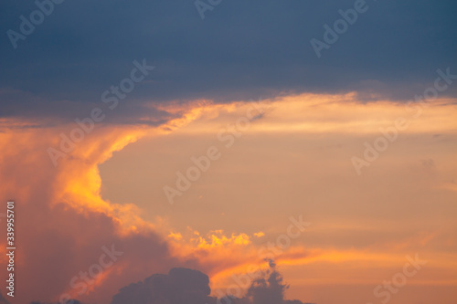 sunset orange and yellow cumulus clouds in a summer day