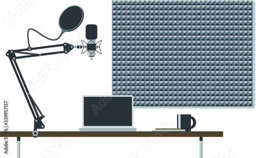 Podcasting desk setup with microphone stand, desk, notebook and acoustic foam wall insulation 