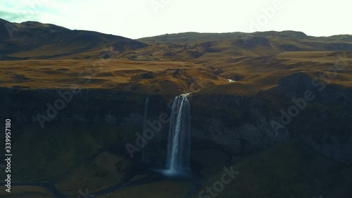 4K aerial footage of amazing waterfalls in South Iceland known as Seljalandsfoss Waterfall during summer season.