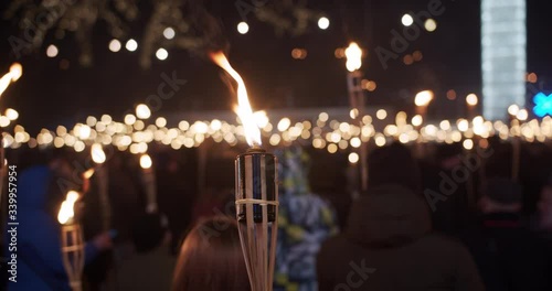 Torchlight procession march at night people with burning torches